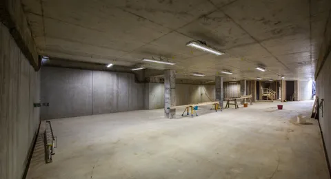 Basement construction by TCON, finished basement, wide lit concrete level