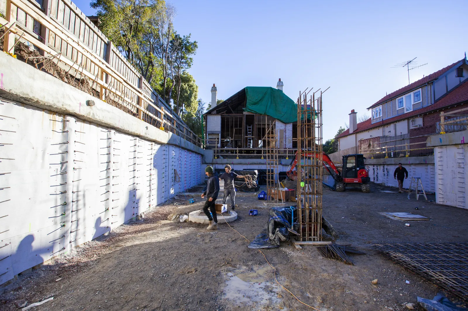 Basement retention walls and formwork with the neighbouring streetscape close behind