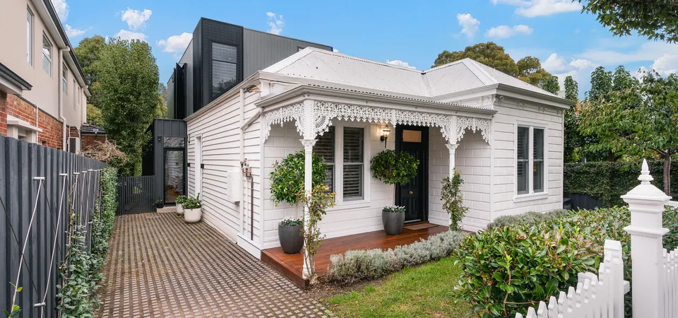 Victorian weatherboard facade with white picket fence and checker path