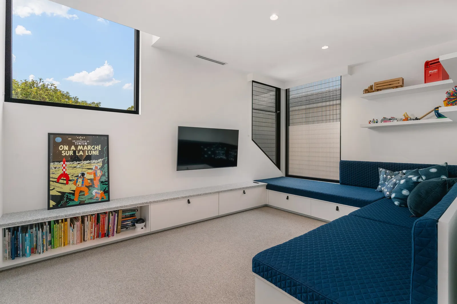 Rumpus room with built-in navy daybed and shelving