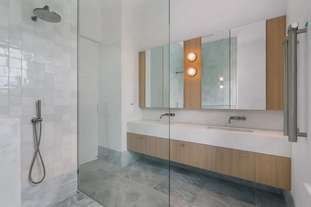 Contemporary ensuite with frameless glass shower, floating oak vanity and double basins